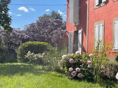 a garden of flowers in front of a building at Domaine La Belle Histoire - Gîte côté jardin in Besset