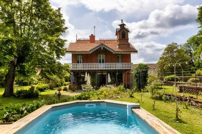 an old house with a swimming pool in front of a house at Domaine La Belle Histoire - Gîte côté jardin in Besset