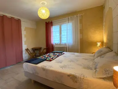 a bedroom with a large bed and a window at Gîte avec jacuzzi, et accès privé à la rivière in Ladern-sur-Lauquet