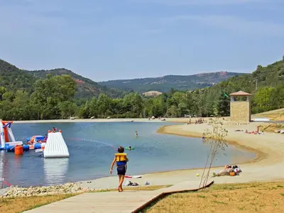 a person running on a beach with a water park at Mountain Retreat w Terrace in Quillan