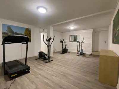 a gym with several exercise bikes in a room at T3 bord canal du midi, piscine in Homps