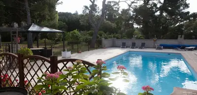 a swimming pool in a yard with a fence at Marsanne cottage for 2 and 2 people in the heart of the vineyard in Badens
