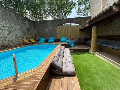 a swimming pool in a yard with a grassy area at Maison indépendante, canal du Midi, Piscine in Homps