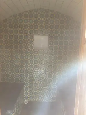 a bathroom with a tiled wall with a window at Fount Estremiero - Chambres & tables d'hôtes in Castans