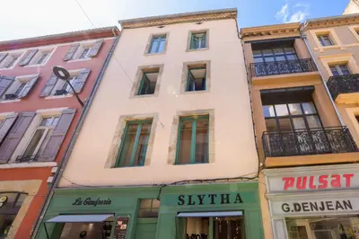 a row of buildings in a street with shops at Balda'Quand Médiéval in Carcassonne