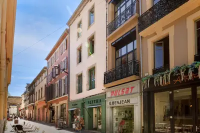 a group of buildings on a city street at MarQue Néo Art in Carcassonne