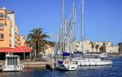 a group of boats docked in a harbor with buildings at Pet Friendly Home In Saint-Laurent-De-La-Ca in Saint-Laurent-de-la-Cabrerisse