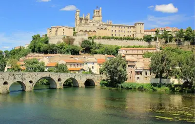 a bridge over a river with a castle in the background at Lovely Home In Saint-Laurent-De-La-Ca in Saint-Laurent-de-la-Cabrerisse