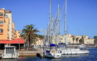 a group of boats docked in a harbor with buildings at 2 Bedroom Lovely Home In Saint-Laurent-De-La-Ca in Saint-Laurent-de-la-Cabrerisse