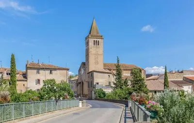 a road in a town with a tower and a church at 2 Bedroom Lovely Home In St-Laurent-De-La-Carbr in Saint-Laurent-de-la-Cabrerisse