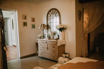 a bedroom with a dresser and a mirror at Belle demeure de charme in Montels