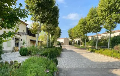 a cobblestone street in a garden with trees at Nice Home In Saint-Laurent-De-La-Ca in Saint-Laurent-de-la-Cabrerisse