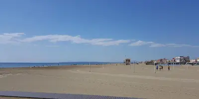a view of a beach with people walking on it at Spacious 60 m nest with sea view in Port-la-Nouvelle
