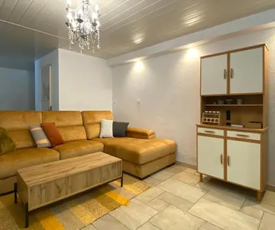a living room with a couch and a coffee table at Maison avec 2 appartements, jacuzzi et accès privé à la rivière in Ladern-sur-Lauquet