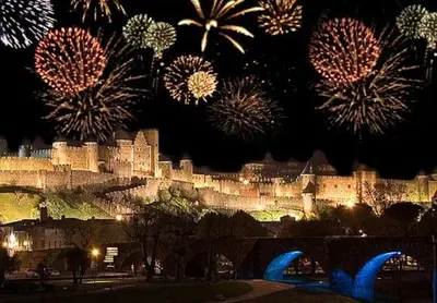 a view of a castle with fireworks in the sky at Appartement Carcassonne résidence capucins in Carcassonne