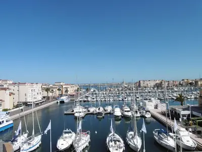 a group of boats docked in a harbor at Gruissan: T3, 4 Pers, Piscine, Parking, Proche Commerce, Environnement Calme, Accès Plage - FR-1-796-14 in Gruissan