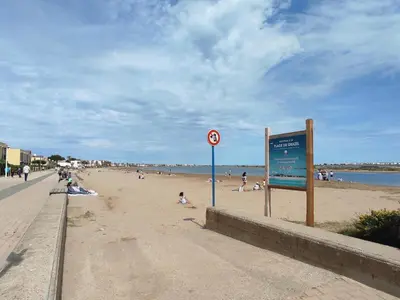 a sign on a beach with people on the beach at Gruissan Studio Vue Mer 2/3 Pers à 50m Plage Grazel, Parking Sécurisé - FR-1-796-47 in Gruissan
