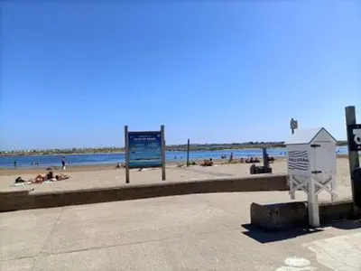 a beach with people on the sand and the water at Gruissan - Appartement climatisé - 6 pers - Parking - Plage à 50m - FR-1-796-51 in Gruissan