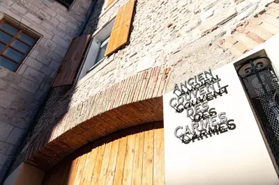 a sign on the side of a brick building at Studio à Baldaquin du Cloitre in Narbonne
