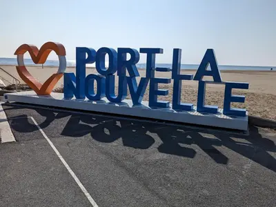 a sign that reads portilla novoille on the beach at Bel appartement T2 climatisé avec piscine et parking à 250m de la plage - FR-1-797-9 in Port-la-Nouvelle