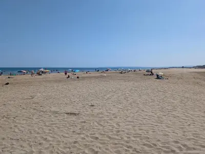 a shadow of a kite on a sandy beach at T2 Climatisé, 2 Cours, Proche Plage, Parking Privé, 5 Pers., Animaux Acceptés - FR-1-797-58 in Port-la-Nouvelle