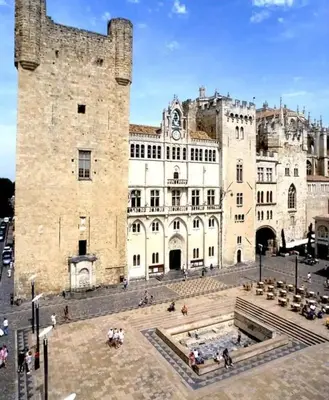 a large stone building with a large castle at Cosy Hypercentre Netflix in Narbonne