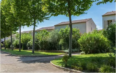 a courtyard with trees and a building at Lovely Home In Saint Laurent De La Ca in Saint-Laurent-de-la-Cabrerisse