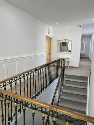 a staircase in a home with white walls at Studio Cosy du Cloitre in Narbonne