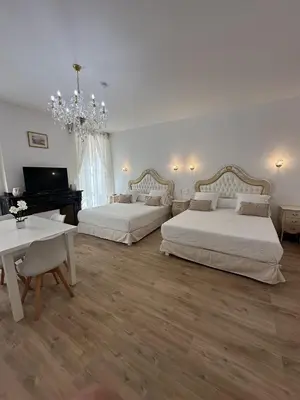 a large bedroom with two beds and a piano at Studio familial du Cloitre in Narbonne