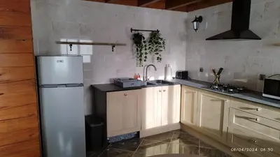 a kitchen with a white refrigerator and wooden cabinets at Chalet 