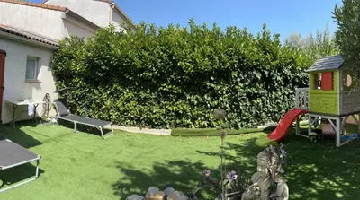 a backyard with a play yard with a playground at CARCASSONNE Studio avec Jacuzzi y piscina in Carcassonne