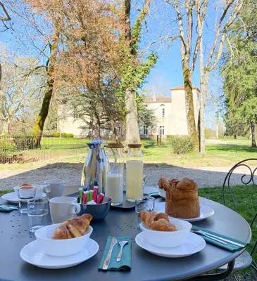 a table topped with plates of pastries and bread at Gîte de Las Cases 4 à 6 personnes in Lempaut