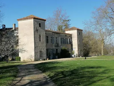 a large building with a grassy field in front of it at Gîte des Cisterciens 7 à 9 personnes in Lempaut