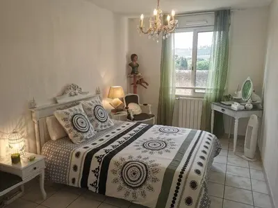 a bedroom with a bed and a window at Chambre avec vue panoramique sur la Cité Médiévale in Carcassonne