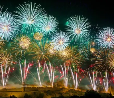a group of fireworks exploding in the night sky at Appartement climatisé avec vue sur la cité in Carcassonne