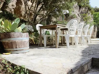 a group of white chairs and a table and a table and chairs at La Roche 8 in Aigues-Vives