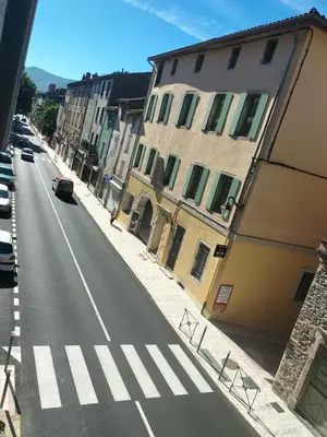 an empty street with a crosswalk in a city at Le petit paradis in Saint-Pons-de-Thomières