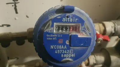 a blue parking meter in front of a pipe at Les Vergers in Narbonne