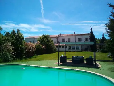a house with a swimming pool in front of a building at Domaine de Polf,ages - just for you and your family in Villautou