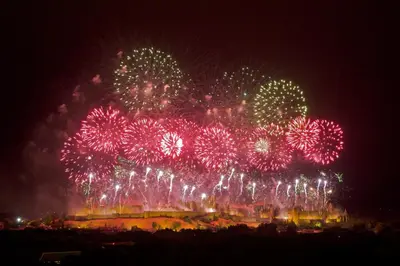 a bunch of fireworks exploding in the sky at night at Au Pied des Remparts-Cité Médiévale in Carcassonne