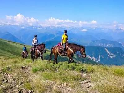 three people riding horses on a hill in the mountains at Cozy Family Getaway Home in Quillan