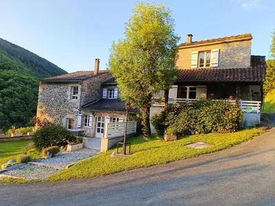 a house on the side of a road at L'oustal in Lacrouzette