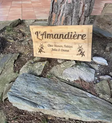 a sign for a tree with a sign for a garden at L'Amandière in Cucugnan