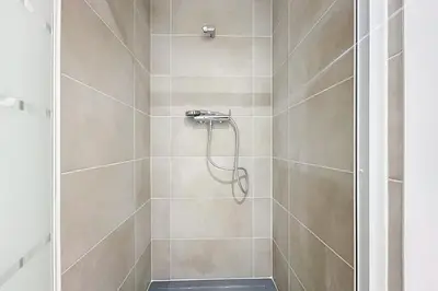 a bathroom with a shower with a glass door at Bright T3 for 4 people in Cuxac-dʼAude
