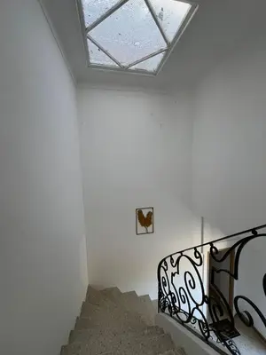 a staircase in a white room with a skylight at Superbe Appart 4 chambres Terrasse vue sur les Montagnes in Saint-Paul-de-Fenouillet