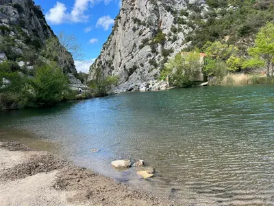 a river with rocks in the water next to a mountain at Superbe Appart 4 chambres Terrasse vue sur les Montagnes in Saint-Paul-de-Fenouillet