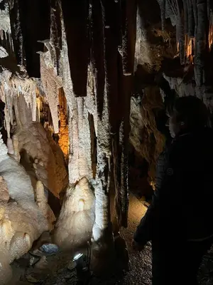 a woman standing in a cave with ice formations at Superbe Appart 4 chambres Terrasse vue sur les Montagnes in Saint-Paul-de-Fenouillet
