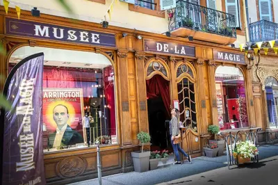 a man standing in front of a store at Le Nid du Pont Neuf in Pamiers