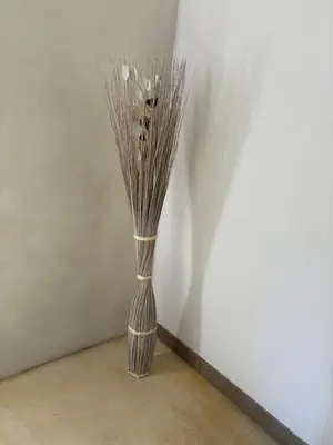 a vase with sticks in it sitting on the floor at Ma petite chaumière in Bouilhonnac