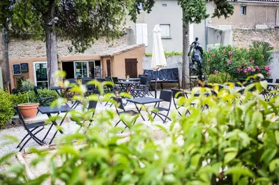 a group of chairs and tables in a yard at CHAMBRE D'HOTE Ô MAZETTE visite de l'Aude in Fabrezan